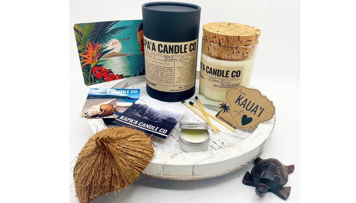 Kapaʻa Candle Club box with candle, collectible tube, postcard, scent story card and sticker.